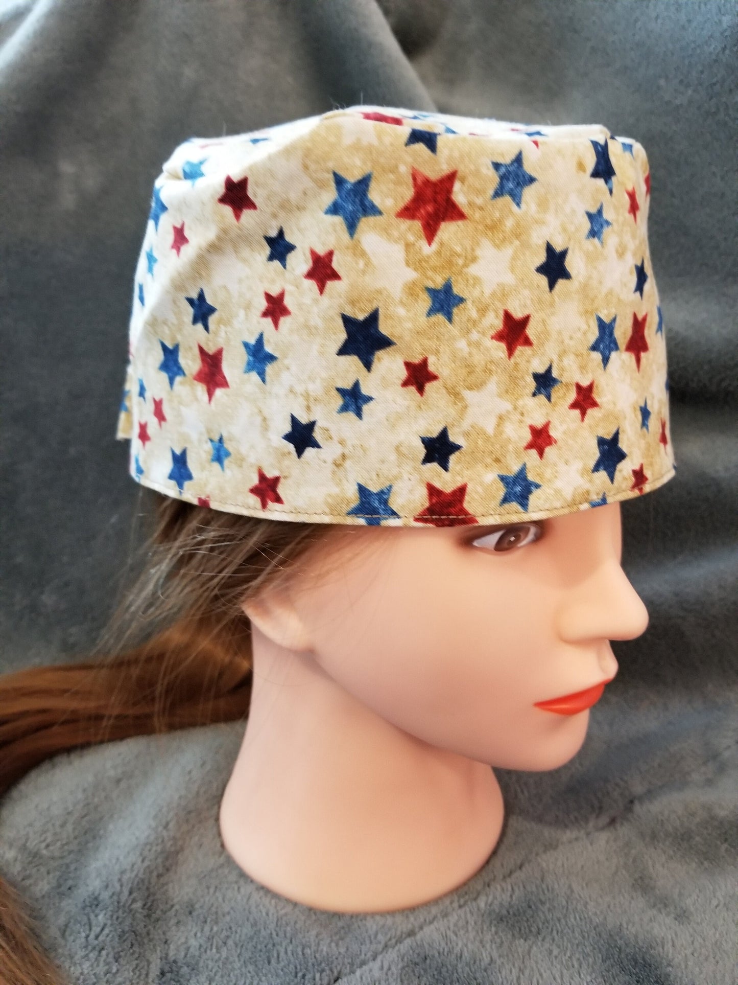 Beige Background with Red and Blue Stars Scrub Cap with hook and loop fasteners