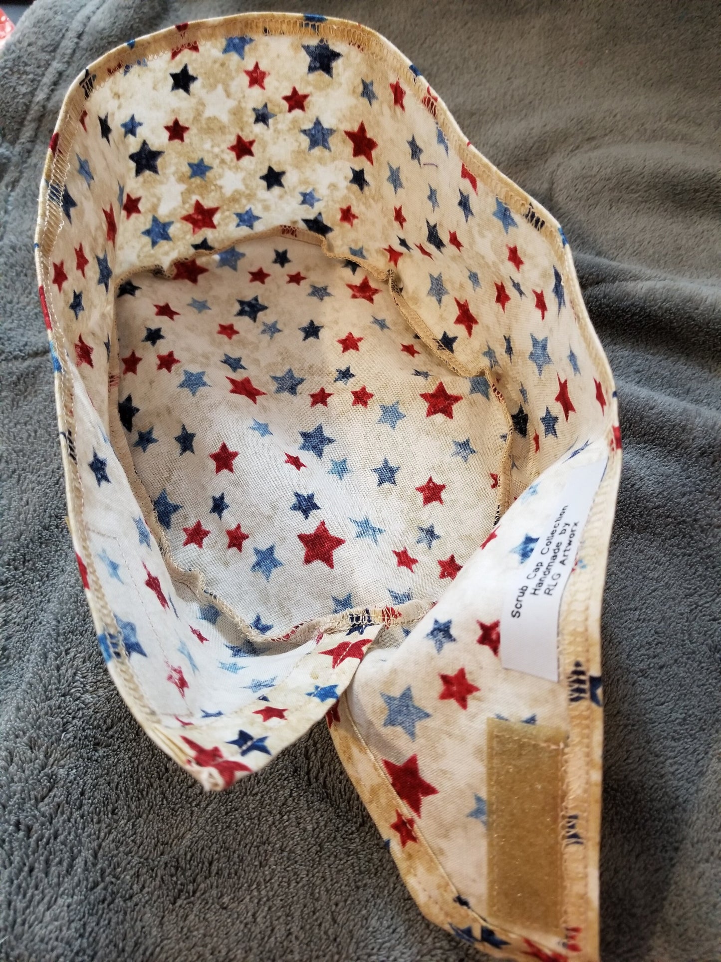 Beige Background with Red and Blue Stars Scrub Cap with hook and loop fasteners