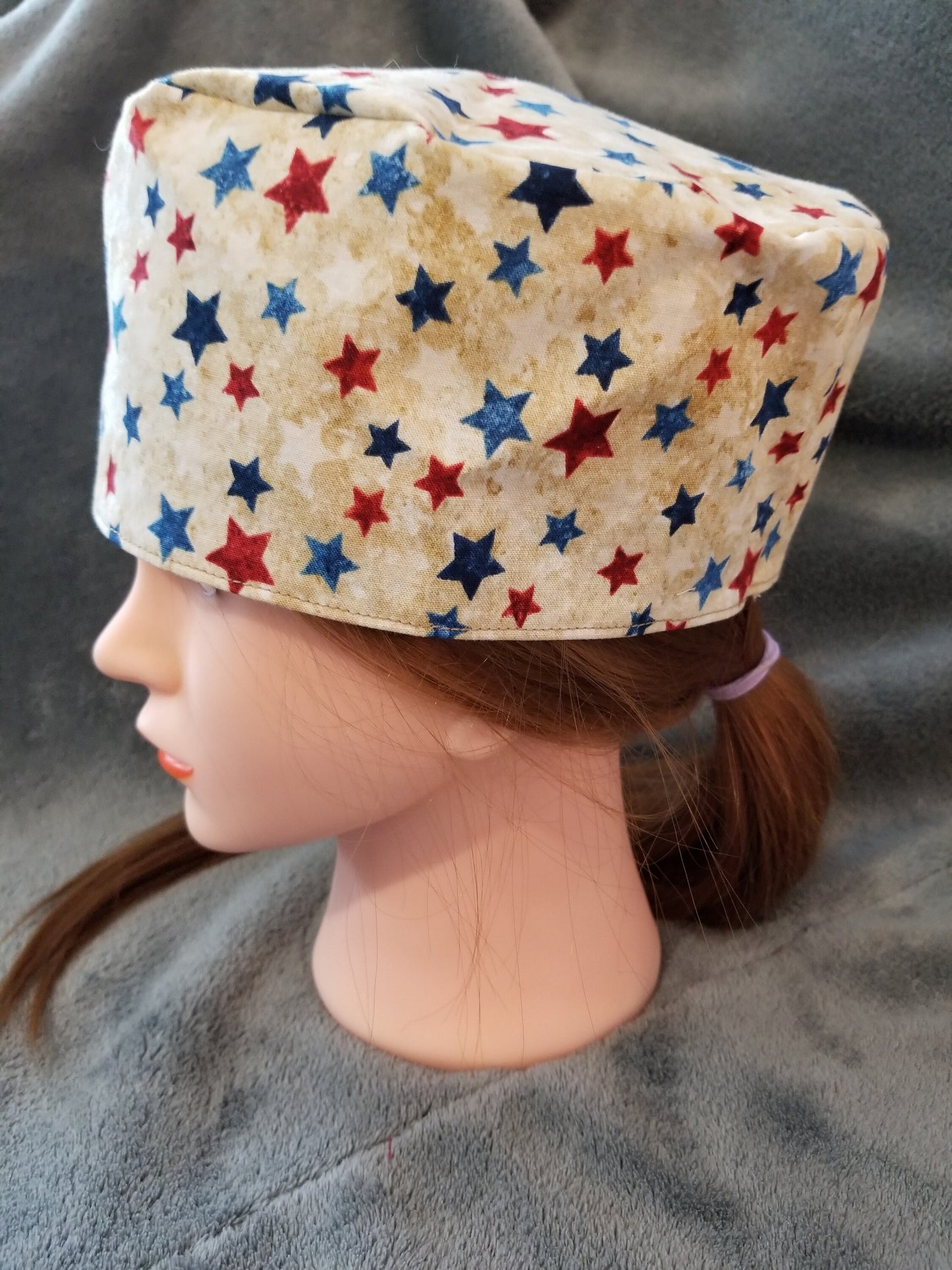 Beige Background with Red and Blue Stars Scrub Cap with hook and loop fasteners